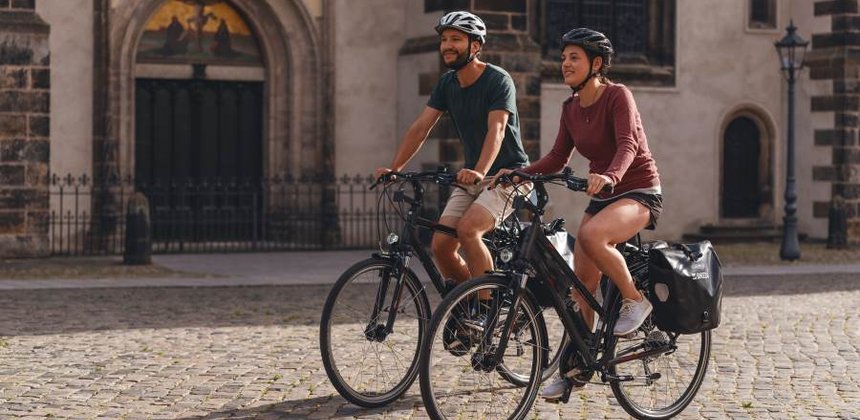 Radfahrer vor der Thesentür der Schlosskirche Wittenberg