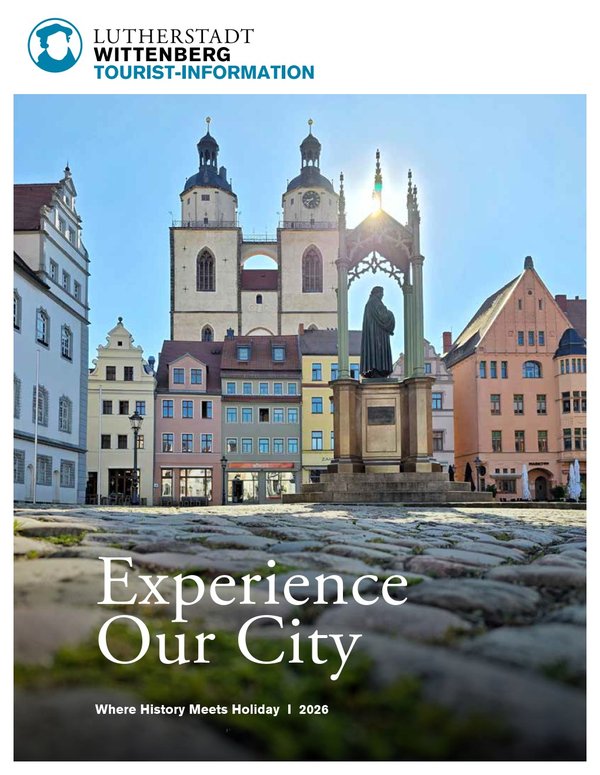 Cover image of the 2026 holiday magazine of the Luther city of Wittenberg with the castle square and Luther monument in the foreground.