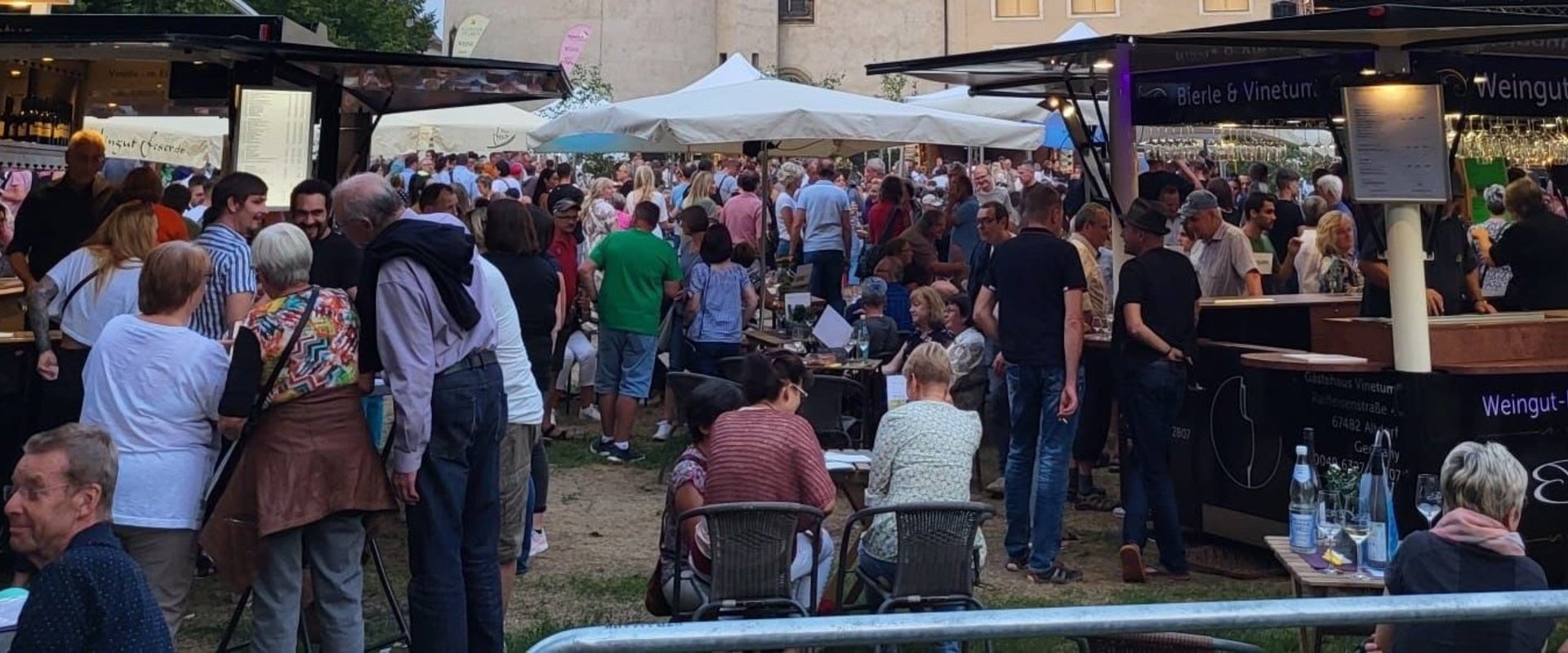 People celebrating at the wine festival in Lutherstadt Wittenberg with a view of the castle church